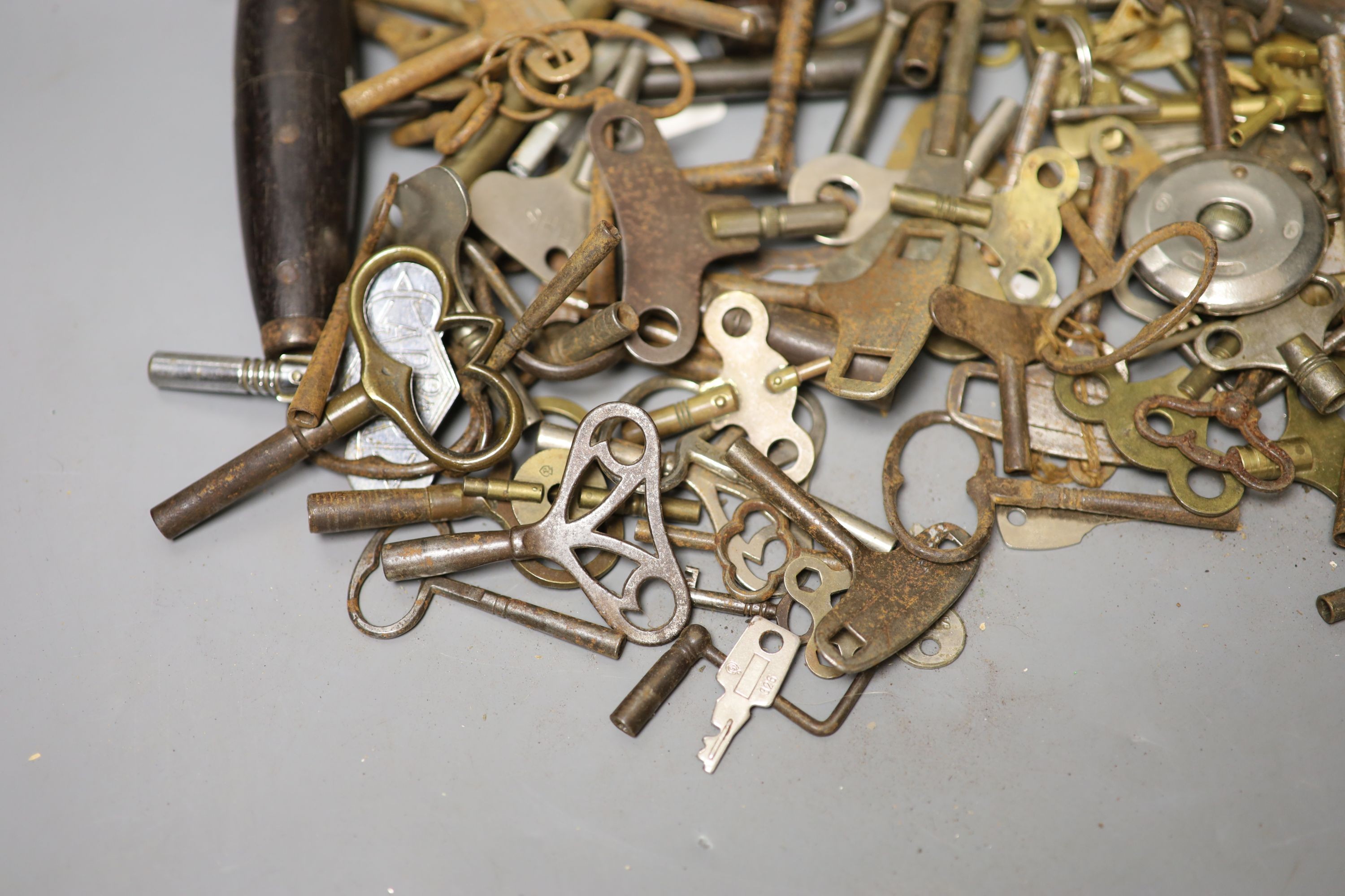 Assorted watch keys and winders and a corkscrew